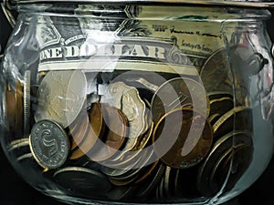 Saving money concept, Dollar banknotes and coins in Glass Jar