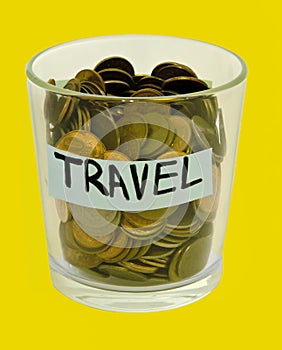 Saving money concept.Glass jars with dollars and text: TRAVEL .Coins in glass jar for money saving financial concept