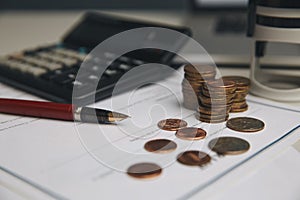 Saving money concept,graph, stacks of coins ,chart and pen ,copy space.selective focus,vintage color