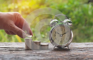 Saving money concept and hand of man putting money coin stack