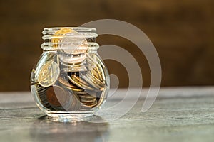 Saving money concept, Money coins in bottle.