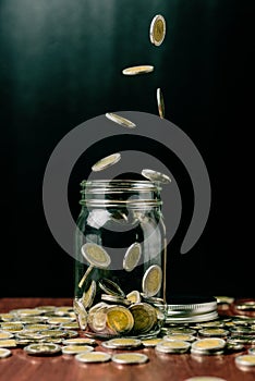 Saving money concept, Money coins fall into bottle