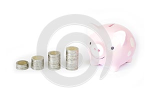 Saving money concept, Piggy bank and coins stacks on white background