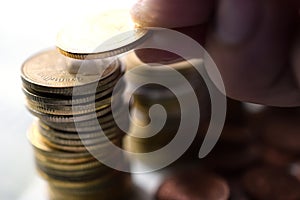 Saving money concept preset by hand putting money coin stack photo