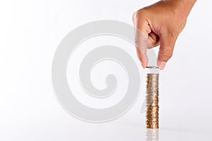 Saving money concept preset by Male hand putting money coin stack growing business