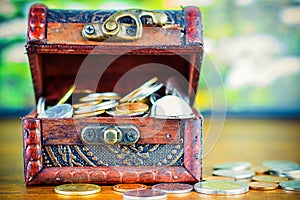 Saving money concept preset putting money coin stack growing business on bright light glowing bokeh background, business finance w photo