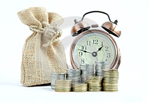 Saving money ,Economizing which have pile of coins ,Clock and money bag on white background. Currency , Investment fund , Business