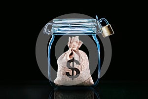 Saving money and financial security concept. Bag with dollar in jar with padlock.