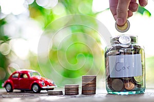 Saving money in a glass bottle, The goal is to buy a car. Saving money concept