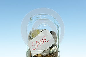 saving money with hand putting coins in jar glass, save and investment money for prepare in the future
