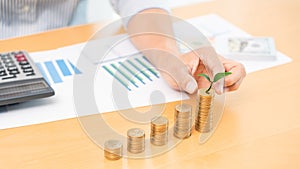 Saving money and investment concept, Business accountant woman stacking coins into increasing columns stack for budget behind desk