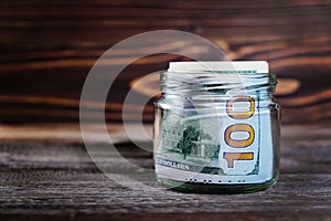 Saving money in jar with American dollars , cash