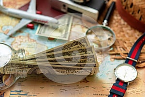 Saving money for Travel.  Top view of Traveler accessories and items man with backpack and visiting for planning travel