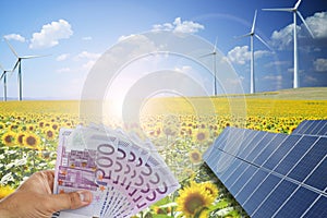 Saving money using green energy from photovoltaic solar panels and wind turbines