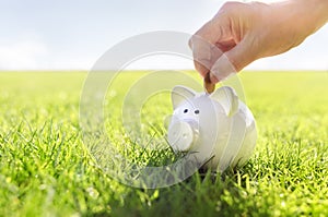 Saving money in white piggy bank, savings, accounting, banking and business account or sustainable finance