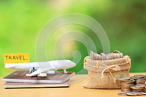 Saving planning for Travel budget of holiday concept,Financial,Stack of coins money in bag and airplane on passport with natural