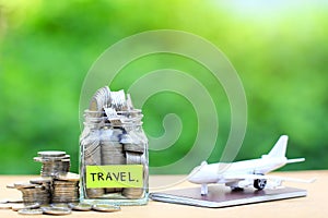 Saving planning for Travel budget of holiday concept,Financial,Stack of coins money in the glass bottle and airplane on passport