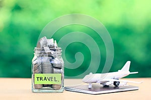 Saving planning for Travel budget of holiday concept,Financial,Stack of coins money in the glass bottle and airplane on passport