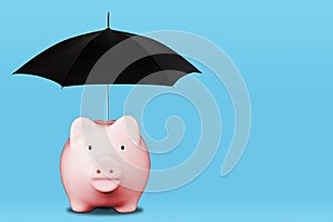 Saving For a Rainy Day Concept With Piggy Bank Shielded From Rain