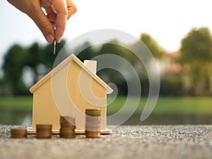 Saving to buy a house that hand putting money coins stack growing ,saving money or money growth concept