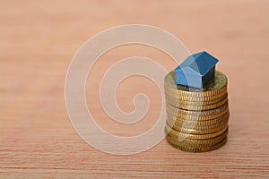 Saving up a fortune in coins for the ultimate goal of purchasing a home, exemplifying the concepts of property acquisition, photo
