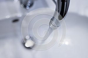 Saving water: Close up of spigot with clear, flowing water