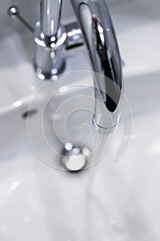 Saving water: Close up of spigot with clear, flowing water