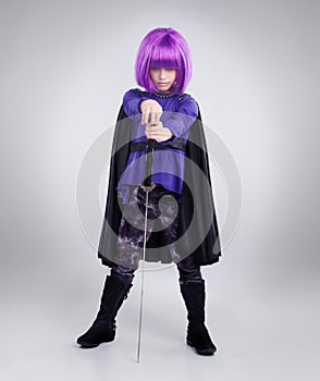Saving the world with imagination. A studio shot of a confident little girl playing dress-up.