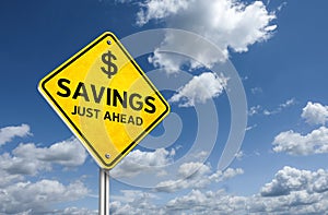 Savings ahead with dollar symbol on traffic road sign