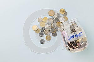 Savings bottle and coins