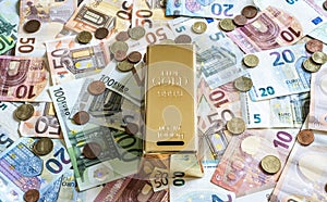 Savings Cash money concept euro banknotes all sizes and cent coins on desk piggy bank gold bar shape save