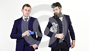 Savings concept. Men in suit, businessmen with jar full of cash and credit card, white background. Mature man prefers