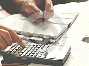 Savings, finances, economy and home concept - close up of man with calculator counting making notes at home