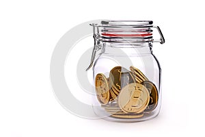 Savings: golden bitcoin coins in a glass jar