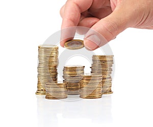 Savings. Investment concept with coins and a hand.