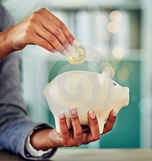 . Savings, investment or a woman putting a coin into a piggybank for financial growth and freedom. Closeup of a female