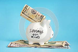 Savings for kids written on a piggy bank