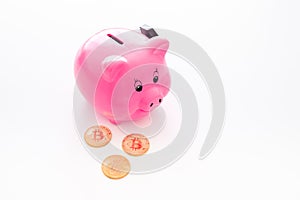 Savings. Moneybox in shape of pig near coins on white background copy space