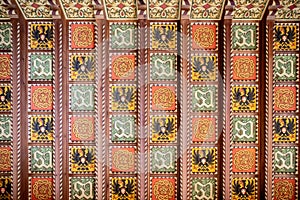 Savoia Castle inside. Wooden coffered ceiling decorated with the Savoia crests. Gressoney Saint Jean, Aosta, Italy photo