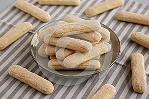 Savoiardi biscuits on a plate, side view