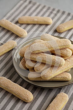 Savoiardi biscuits on a plate, side view