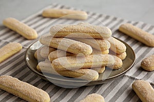 Savoiardi biscuits on a plate, side view