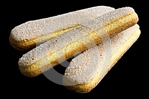 Savoiardi italian sponge biscuits isolated on black.