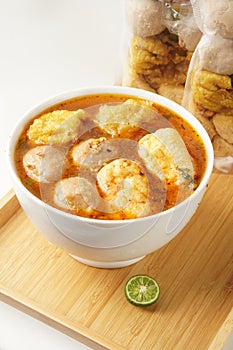 Savor a bowl of Cuankie meatball soup with round meatballs, tofu, fried wontons, and savory spicy broth