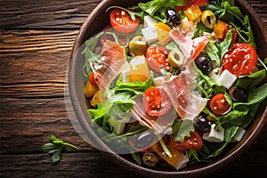 Savor the season Vibrant summer salad featuring olives, tomatoes, and prosciutto