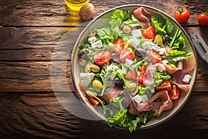 Savor the season Vibrant summer salad featuring olives, tomatoes, and prosciutto