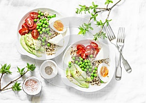 Savory breakfast grain bowl. Balanced buddha bowl with quinoa, egg, avocado, tomato, green pea on light background. Healthy diet