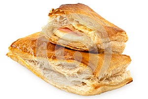 Savory filled puff pastry on top of whole puff pastry isolated on white
