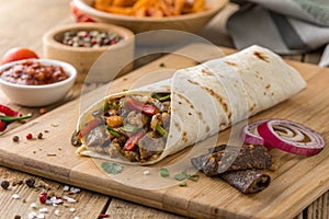 Savory Meat Wrap on Wooden Table Close-Up - generated by ai