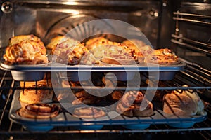 Savory muffins and pastries baking in an oven, the warmth of the kitchen highlighting the comfort of homemade cooking.